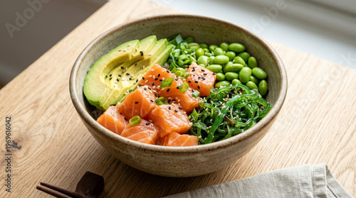 Hawaiian salmon poke bowl with cubed fresh raw fish, avocado, edamame, and seaweed on a rustic wooden table, 45-degree angle food photography, dense composition.