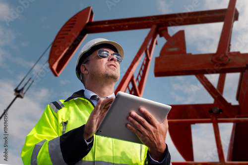Construction engineer wearing safety vest and oil industry pumps