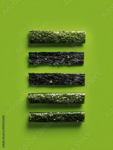 Arrangement of Nori Seaweed Strips on Green Background