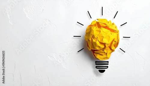 creative idea concept with a yellow crumpled paper shaped like a lightbulb on white background with copy space