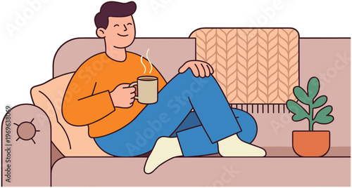 A man sits on a couch drinking from a mug next to a plant.