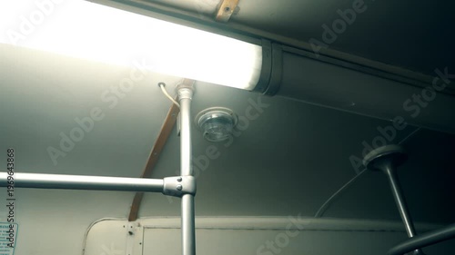 Light fixture and ceiling detail in a public transport vehicle during the day