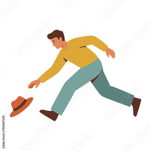 Man runs quickly to catch his falling hat on the ground outside