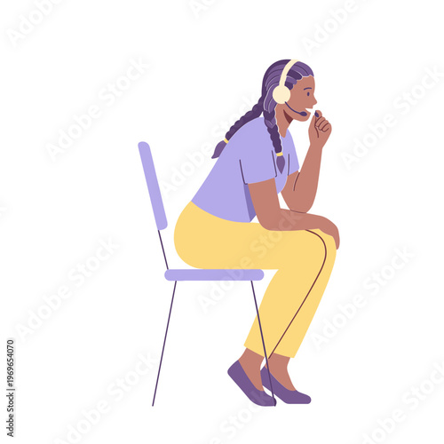 Woman sits on chair wearing headphones and looking relaxed indoors