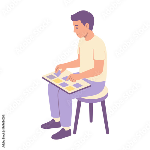 Man sitting on stool working on puzzle board with pieces