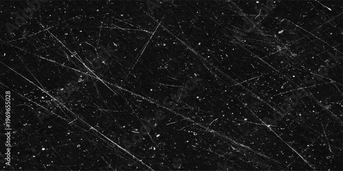 Abstract a mesmerizing image of a worn, dark surface reveals intricate scratches and marks, like a secret map or a testament to time and usage. The textured background evokes a sense of age, history.