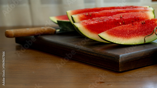 Slicing Fresh Juicy Watermelon on Wooden Cutting Board for Summer Snack
