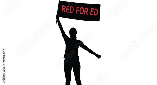 Protester raises a banner reading red for ed a silhouette