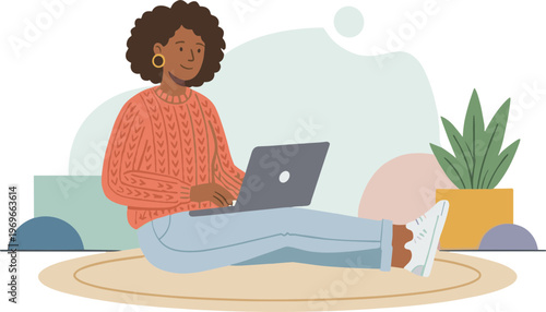 Woman working on laptop at home with plant nearby on floor