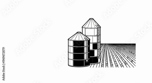 Two farm silos stand tall next to a field of crops