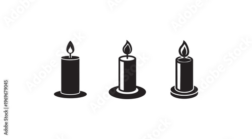 Three black candles with flames burning on top  isolated on white background