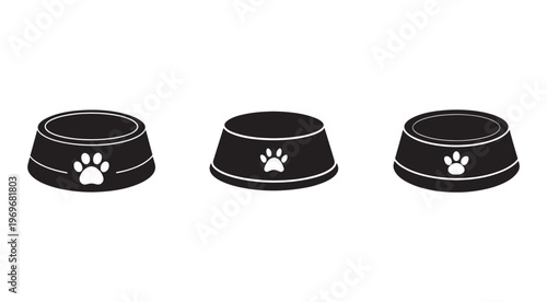 Three black dog food bowls with white paw prints on the side  isolated on white background