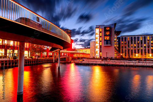 Copenhagen bike path at dusk, modern architecture in Danish capital.