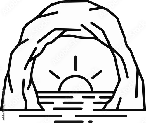 Sun setting over water viewed from a cave opening