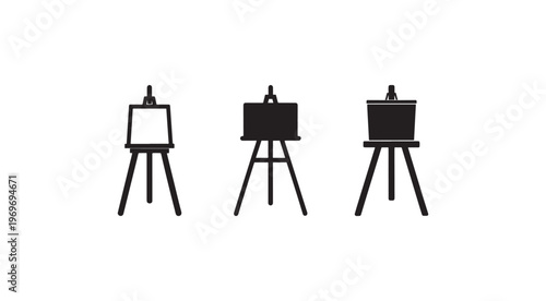 Three easels with blank white and black canvases on stands for painting and drawing  various art display options