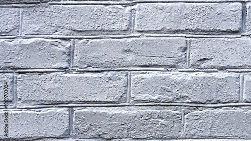 background, brick wall in fresh whitewash. brick wall facade texture. old grey bricks in an exterior uneven wall of a house with whitewashed worn plaster. masonry, construction, repair, restoration