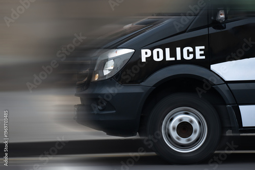 A fast police car speeding on the road, showcasing law enforcement response, high performance, and emergency mobility in urban or highway settings.