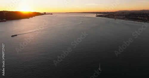 Sunset aerial skyline of Lisbon Portugal 25th April red suspension bridge famous iconic landmark over Tagus