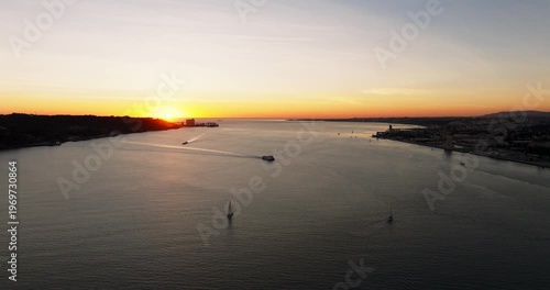 Scenic golden sunset of Lisbon Portugal 25th April red suspension bridge famous iconic landmark and skyline