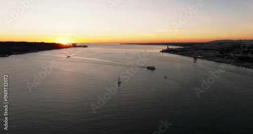Cinematic sunset skyline of Lisbon Portugal 25th April red suspension bridge famous iconic landmark