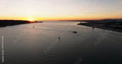 Aerial sunset vista featuring Lisbon Portugal 25th April red suspension bridge famous iconic landmark