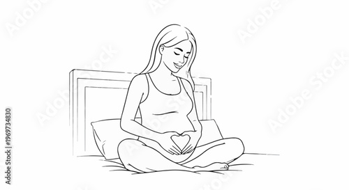 Pregnant woman sitting on bed, hands forming heart shape on belly