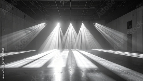 Dramatic Stage Lighting in a Large Empty Room Creates a Sense of Mystery and Suspense in a Black and White Image.
