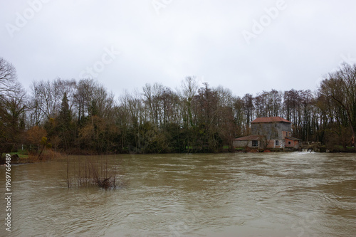 Seasonal inundation. Marne river flood in Champagne, France. Abandoned house near sluice. High water background. Economic damage concept.