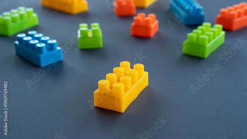 Fotografie Close Up of Yellow Plastic Building Block with Blurred Background