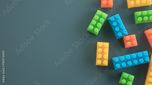 Tableau sur toile Minimalist Composition of Colorful Childrens Blocks on Dark Gray Surface