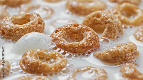 Close-up macro lens view of cereal rings floating in milk, showcasing the texture and bubbles, with a focus on the intricate details of the breakfast scene