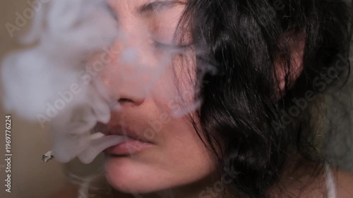 close up shot of depressed woman smoking in slow motion