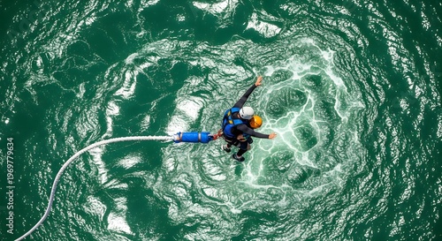 Extreme sports thrill seekers leap from a height, tethered by bungee cords, over swirling green waters from an aerial view