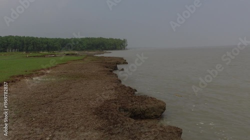 A view of the riverbank in the erosion-affected area of Char Hassan area of Bhola district. Water is rushing along the riverbank in the river erosion area. 