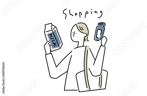 牛乳を手に取って見比べる買い物中の女性