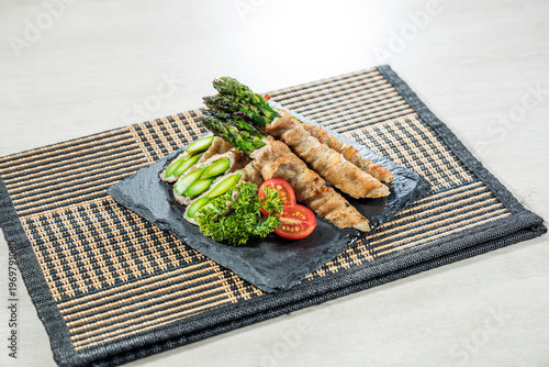 Grilled pork wrapped asparagus skewers platter