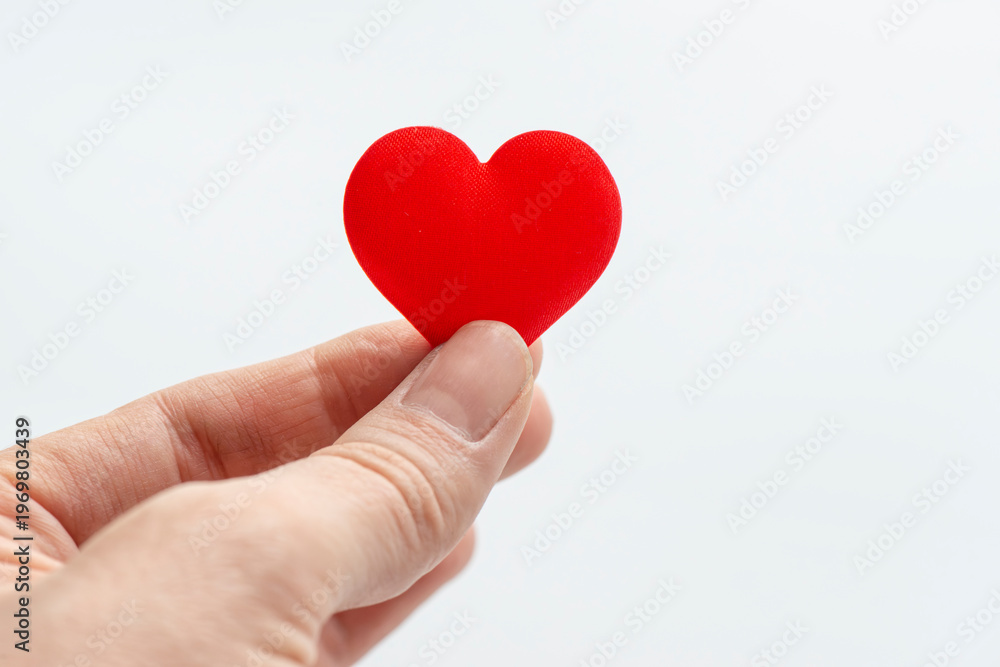 Obraz premium Hand Holding Red Heart Shape