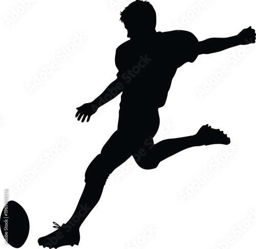 Silhouette of a male football player kicking a ball during a game action