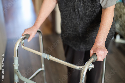 Bilde på lerret Senior woman using a walker for mobility support