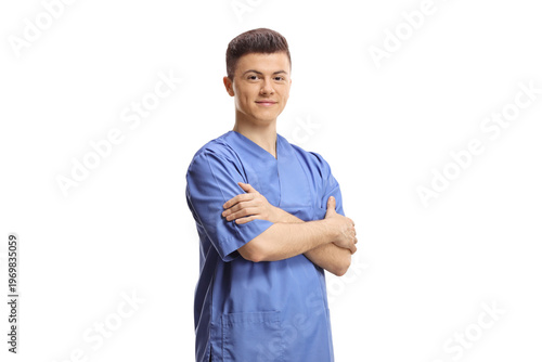 Male intern worker in a blue uniform posing with crossed arms