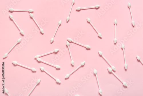 Cotton buds on pink background