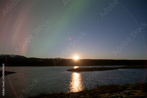 Aurora borealis moonrise over Thingvellir lake Iceland