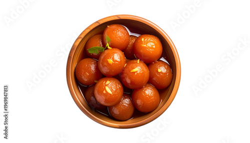 Overhead shot of dark, shiny, spherical, syrup-soaked desserts in a wooden bowl on black