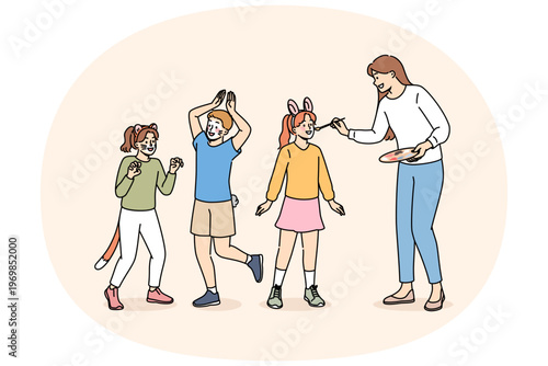 Children party dedicated to animals, with face painting for boys and girls from caring woman artist. Happy children rejoice with painted faces for themed party or masquerade on eve of animal day