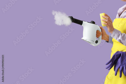 Female janitor with steam c...