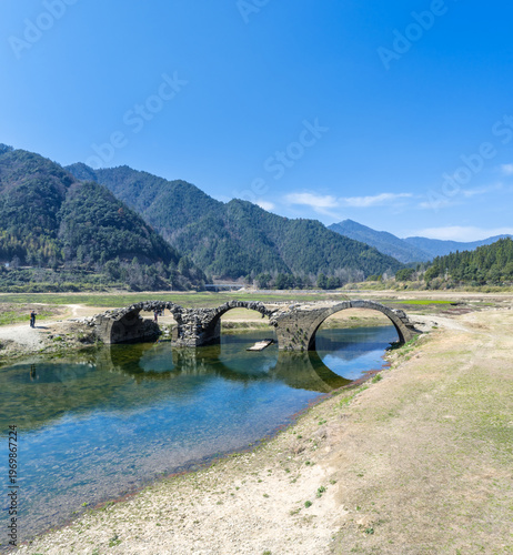 Wallpaper Mural Ancient Stone Arch Bridge Spanning a Clear River Torontodigital.ca