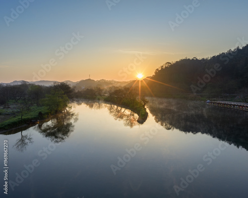 Wallpaper Mural Sunrise at Wuyuan Moon Bay with Radiant Sunburst and Mirror-Like River Reflections Torontodigital.ca