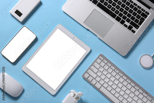 Schilderij op canvas Tablet computer with different modern gadgets on blue background