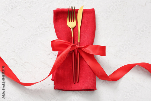 Golden cutlery with napkin ...
