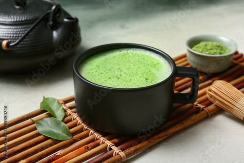 Obraz na płótnie Cup of matcha tea with powder and chasen on grunge background, closeup